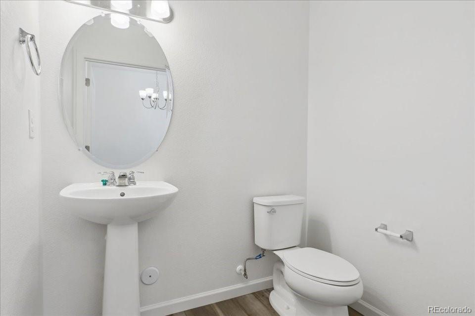 6800 Merseyside Lane, Unit 166 Castle Pines, CO 80108 - Photo 7 of 21 a bathroom with a toilet a sink and a mirror