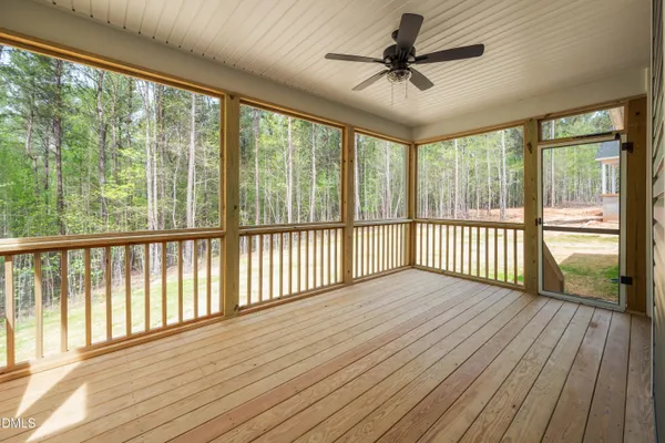 a view of a porch with wooden floor