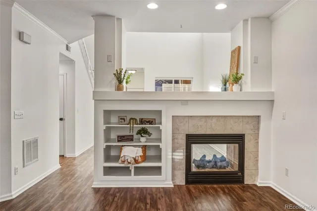 a living room with stainless steel appliances kitchen island granite countertop furniture and a refrigerator