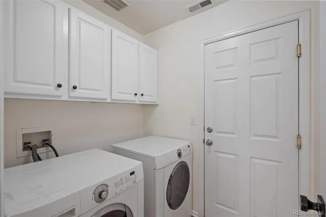 a bathroom with a sink a toilet a mirror and shower