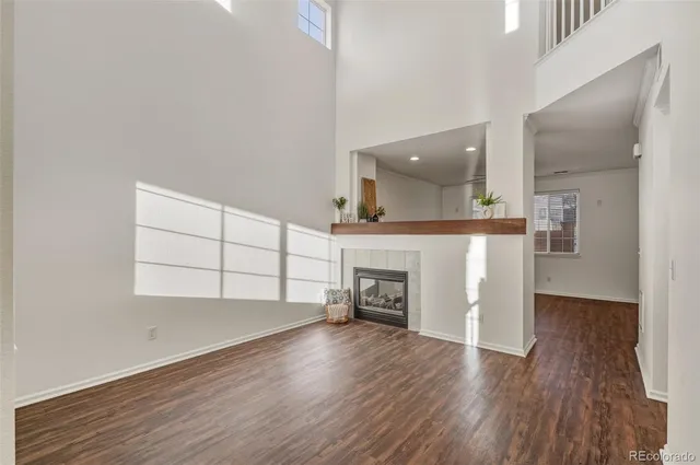 a view of an empty room with a window and fireplace