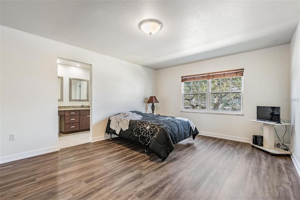 701 Poinsettia Road, Unit 248 Belleair, FL 33756 - Photo 16 of 38 a bedroom with a bed and a tv on table