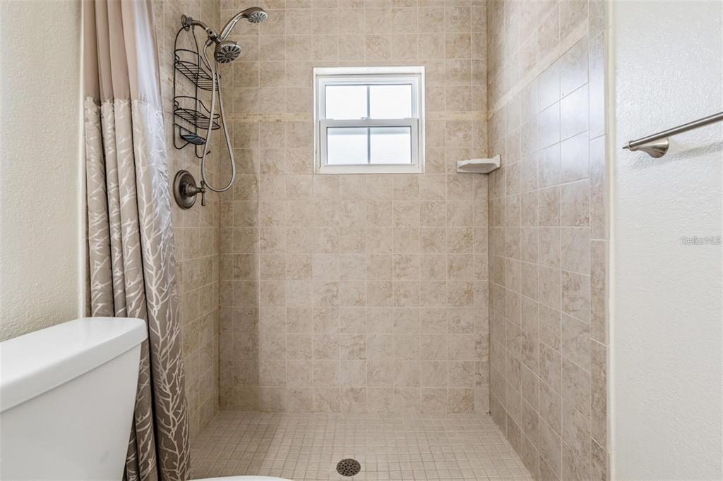 701 Poinsettia Road, Unit 248 Belleair, FL 33756 - Photo 20 of 38 a bathroom with a shower