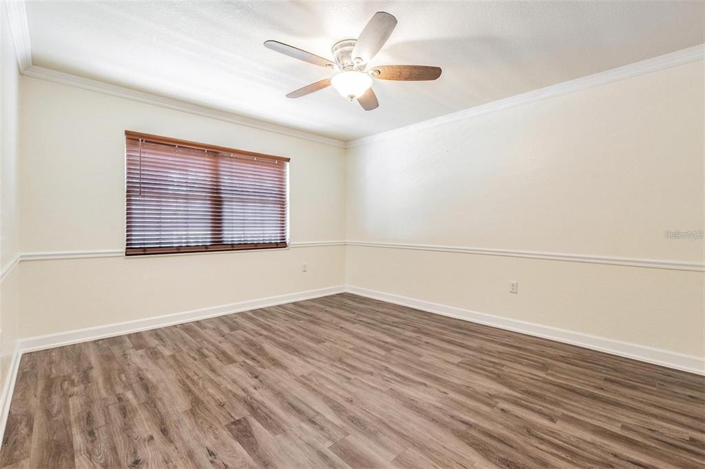 701 Poinsettia Road, Unit 248 Belleair, FL 33756 - Photo 23 of 38 an empty room with wooden floor and windows