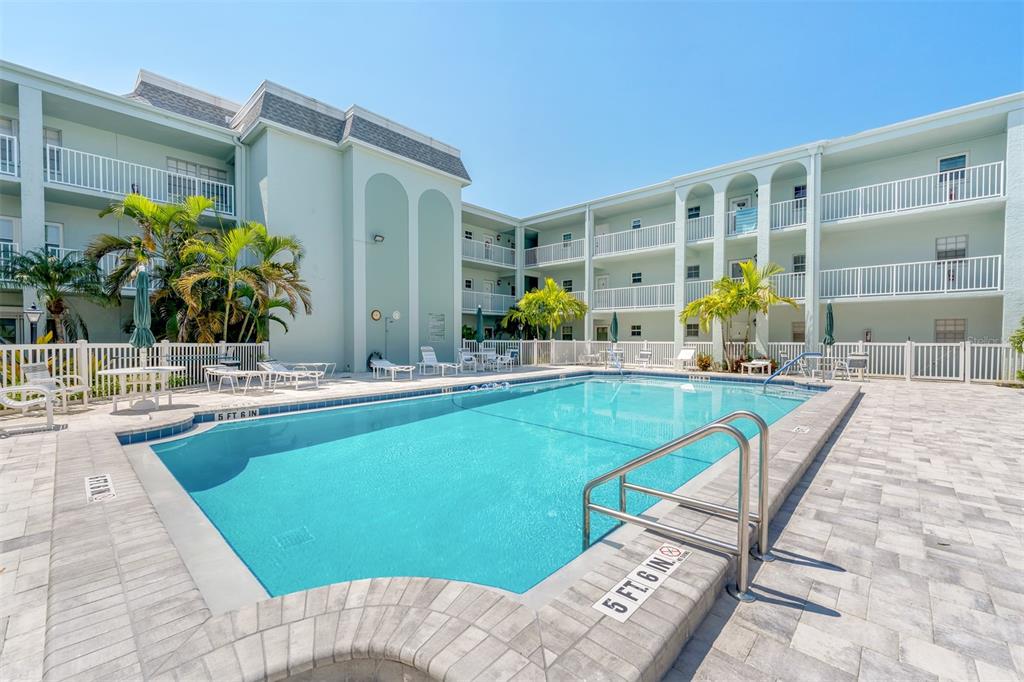 701 Poinsettia Road, Unit 248 Belleair, FL 33756 - Photo 24 of 38 a swimming pool with outdoor seating and yard