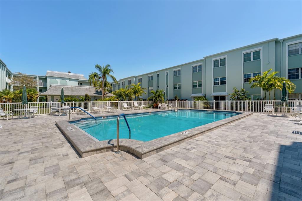 701 Poinsettia Road, Unit 248 Belleair, FL 33756 - Photo 25 of 38 a swimming pool with outdoor seating and yard
