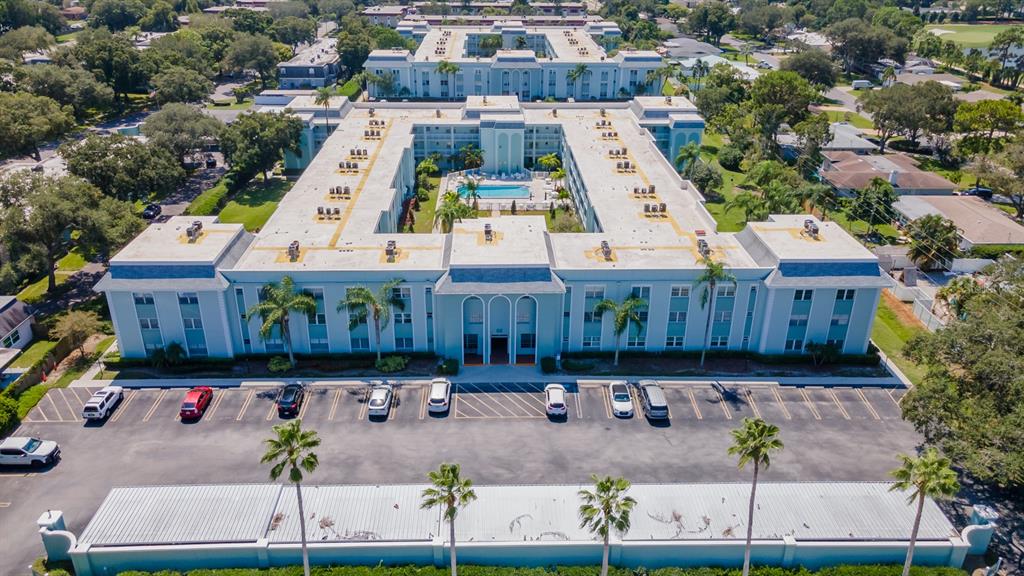 701 Poinsettia Road, Unit 248 Belleair, FL 33756 - Photo 26 of 38 an aerial view of a house with large trees and lawn chairs