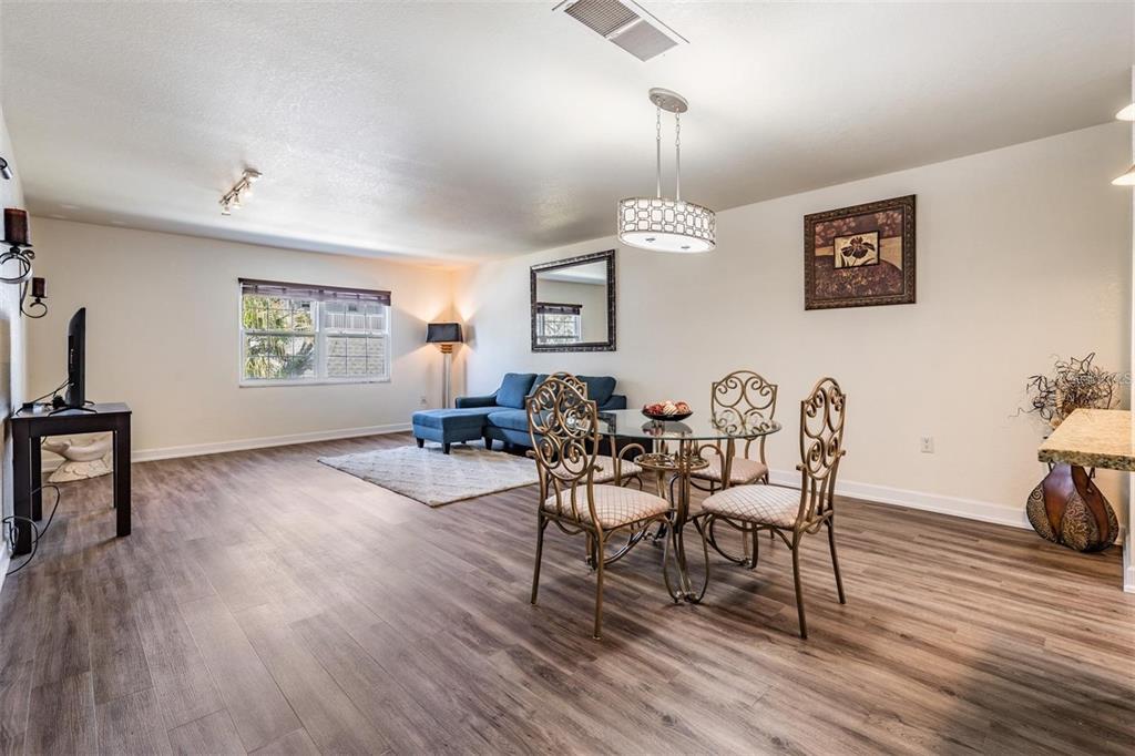 701 Poinsettia Road, Unit 248 Belleair, FL 33756 - Photo 3 of 38 a view of a dining room with furniture window and wooden floor
