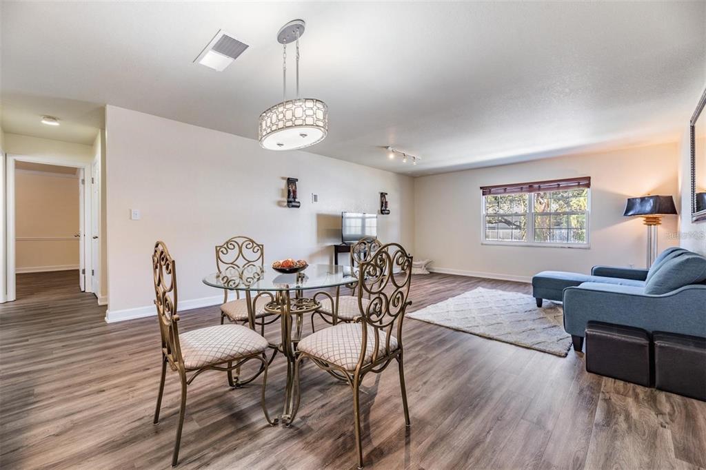 701 Poinsettia Road, Unit 248 Belleair, FL 33756 - Photo 4 of 38 a view of a dining room with furniture wooden floor and chandelier