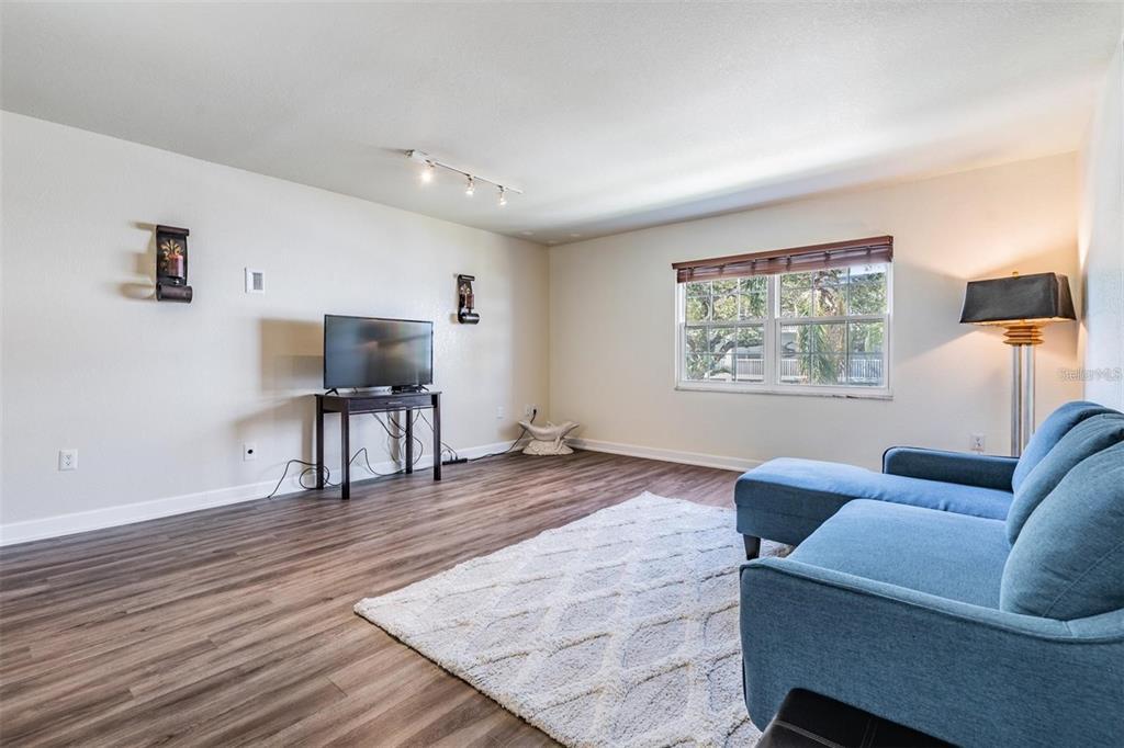 701 Poinsettia Road, Unit 248 Belleair, FL 33756 - Photo 5 of 38 a living room with furniture and a wooden floor
