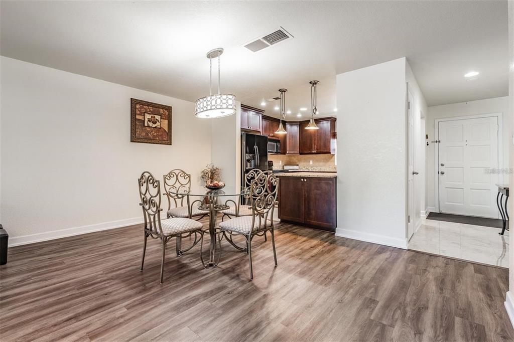 701 Poinsettia Road, Unit 248 Belleair, FL 33756 - Photo 6 of 38 a view of a dining room with furniture and wooden floor