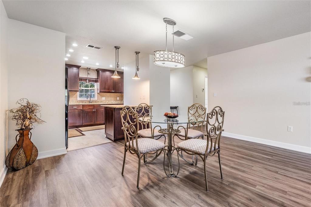 701 Poinsettia Road, Unit 248 Belleair, FL 33756 - Photo 7 of 38 a view of a dining room with furniture and wooden floor