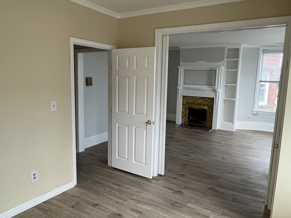 5 State Street, Unit 4F Worcester, MA 01609 - Photo 3 of 9 a view of a livingroom with wooden floor and a fireplace