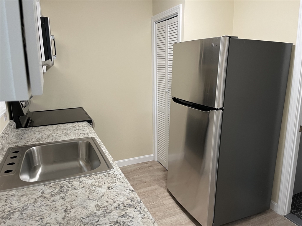 5 State Street, Unit 4F Worcester, MA 01609 - Photo 6 of 9 a close view of a refrigerator and a sink