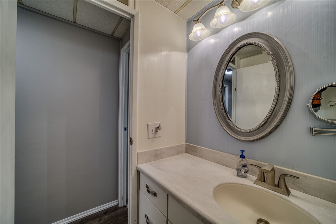 4826 Powell Lake Road Topock, AZ 86436 - Photo 24 of 58 a bathroom with a granite countertop sink and a mirror