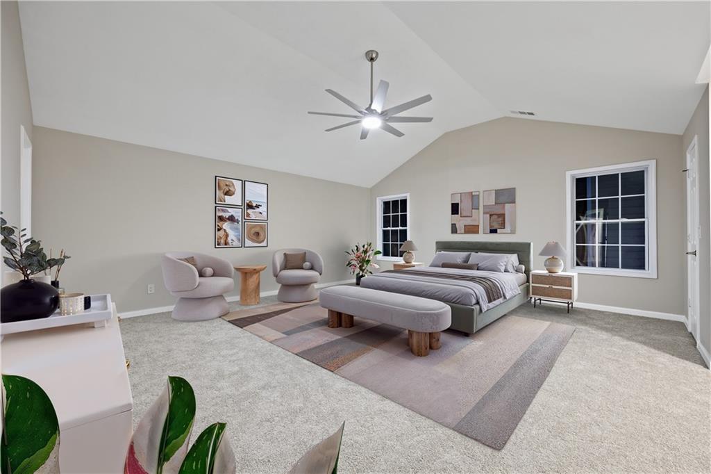 1549 Stewart Ridge Drive Buford, GA 30518 - Photo 12 of 32 a spacious bedroom with a bed couch and a window