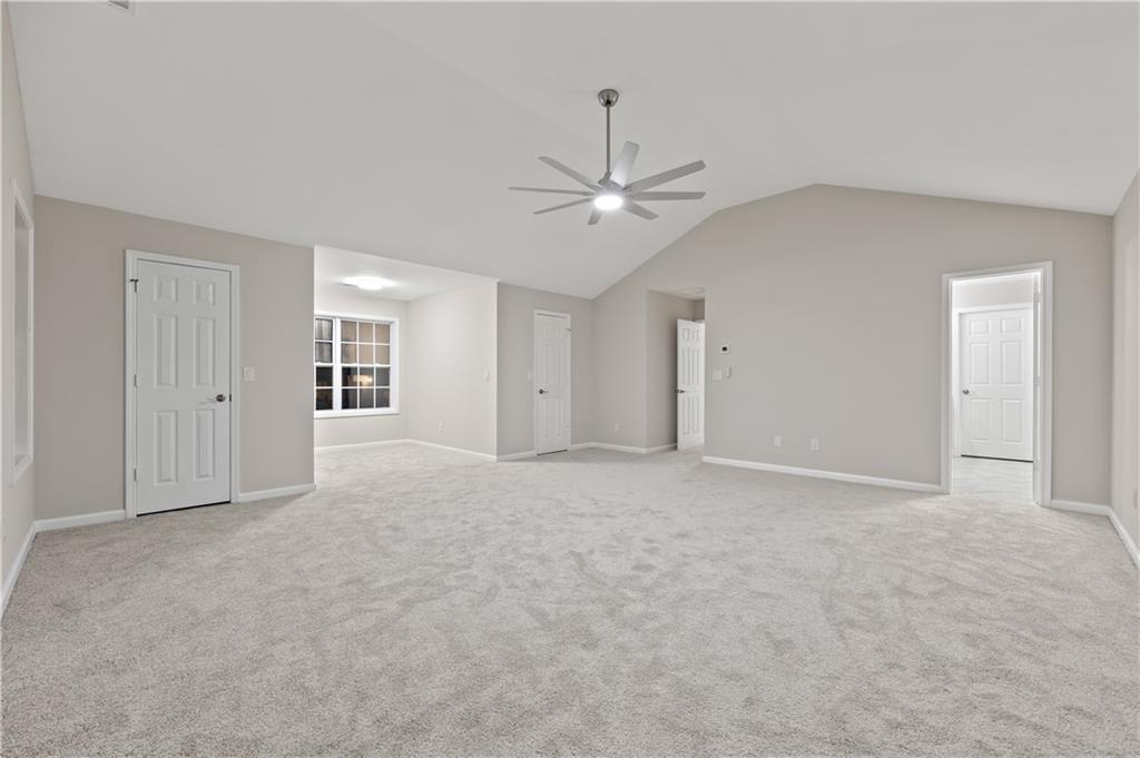 1549 Stewart Ridge Drive Buford, GA 30518 - Photo 14 of 32 a view of an empty room with a ceiling fan
