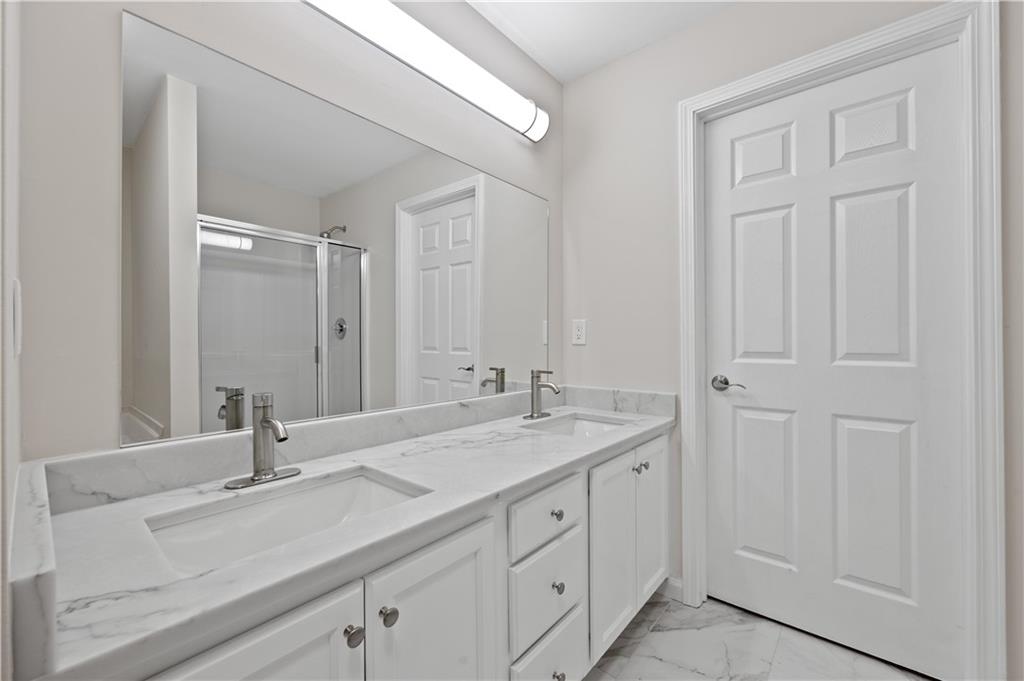 1549 Stewart Ridge Drive Buford, GA 30518 - Photo 15 of 32 a bathroom with a sink and a mirror