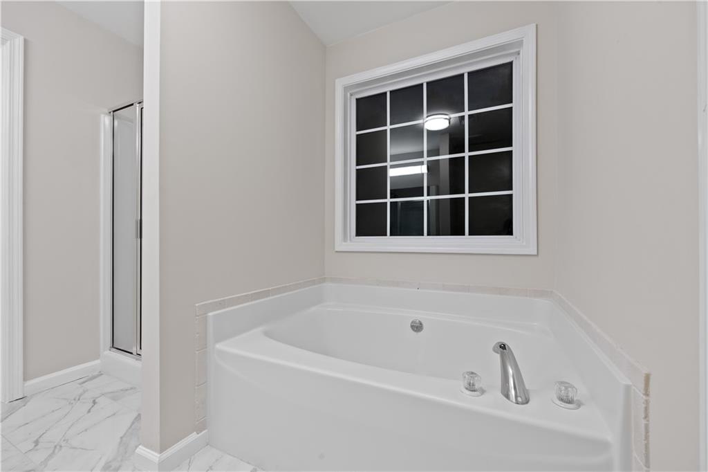 1549 Stewart Ridge Drive Buford, GA 30518 - Photo 16 of 32 a white bath tub sitting next to a window