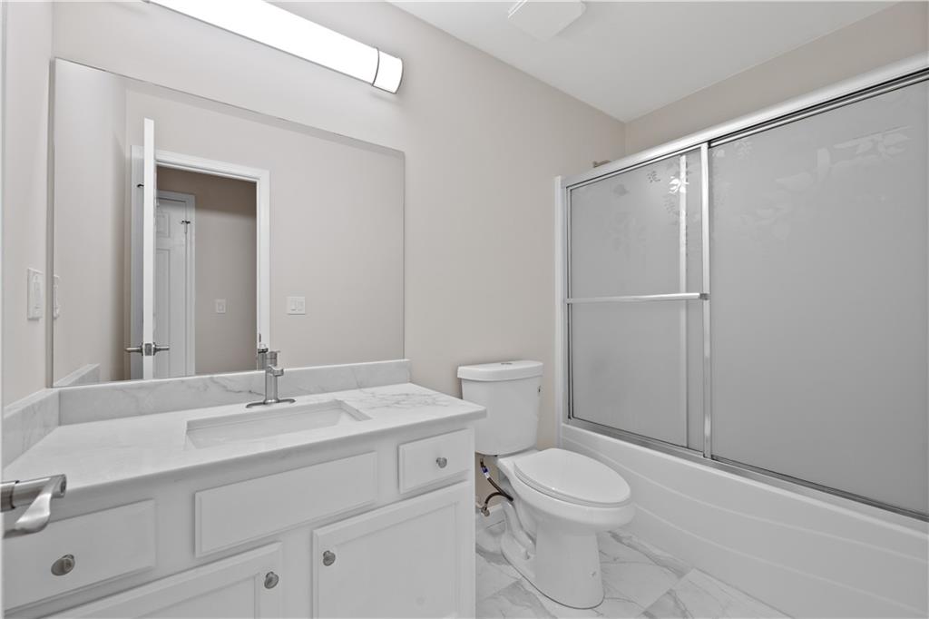 1549 Stewart Ridge Drive Buford, GA 30518 - Photo 21 of 32 a bathroom with a sink a toilet and shower