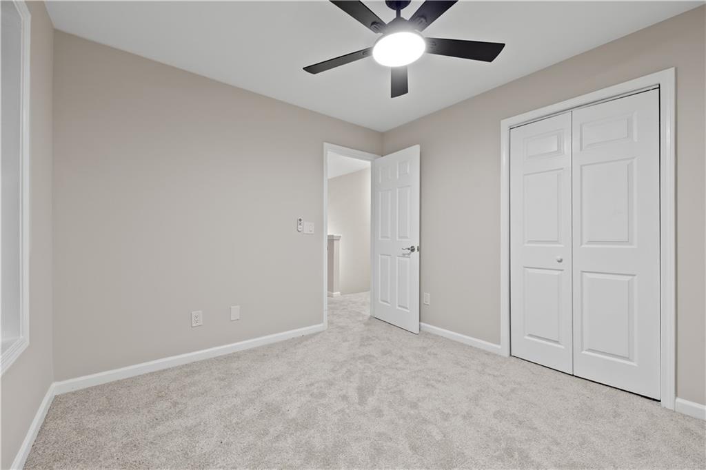 1549 Stewart Ridge Drive Buford, GA 30518 - Photo 23 of 32 an empty room with chandelier fan