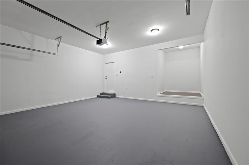 1549 Stewart Ridge Drive Buford, GA 30518 - Photo 28 of 32 an empty room with a ceiling fan and wooden floor