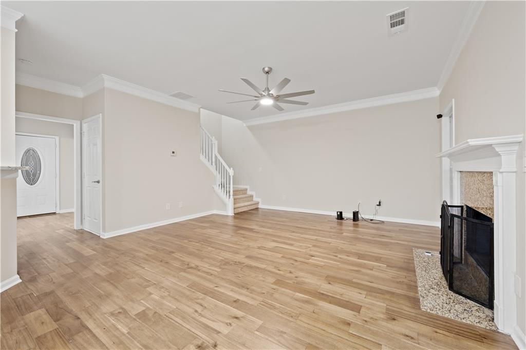 1549 Stewart Ridge Drive Buford, GA 30518 - Photo 9 of 32 a view of empty room with fireplace and wooden floor