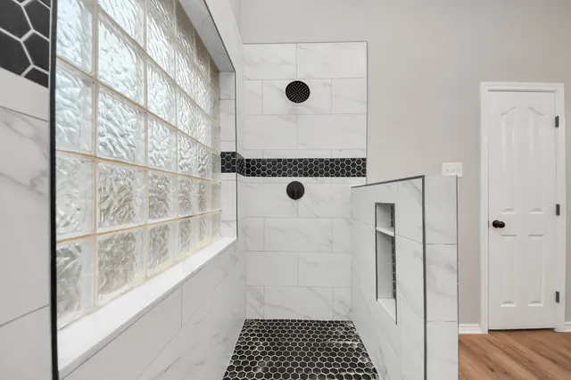 a view of an empty room with wooden floor