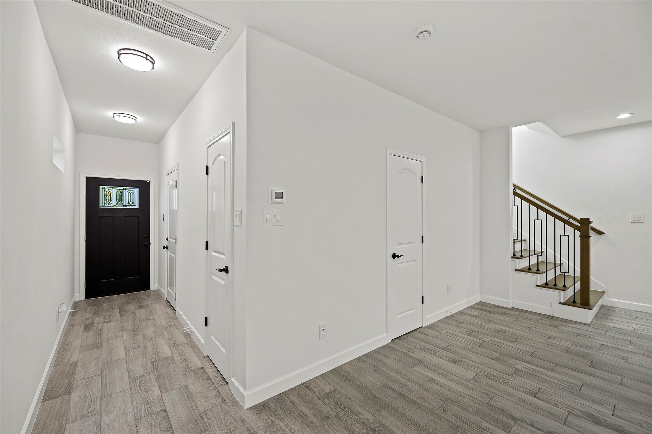 1071 St Clair Street Houston, TX 77088 - Photo 3 of 31 a view of a hallway with wooden floor and staircase
