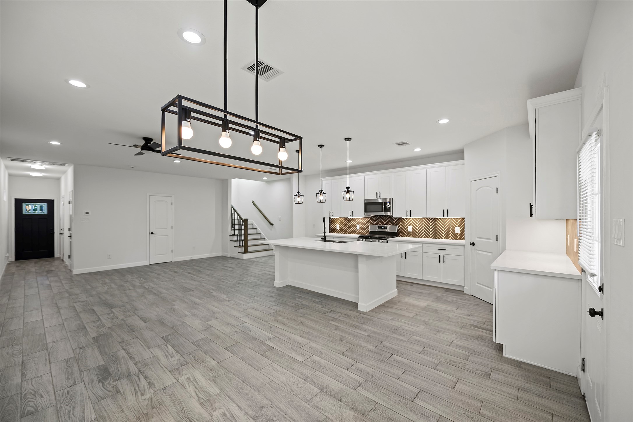 1071 St Clair Street Houston, TX 77088 - Photo 7 of 31 a kitchen with stainless steel appliances a refrigerator and white cabinets