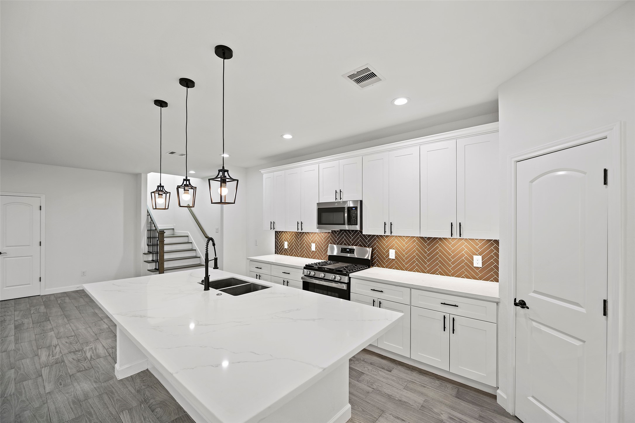 1071 St Clair Street Houston, TX 77088 - Photo 10 of 31 a kitchen with a sink a stove and cabinets