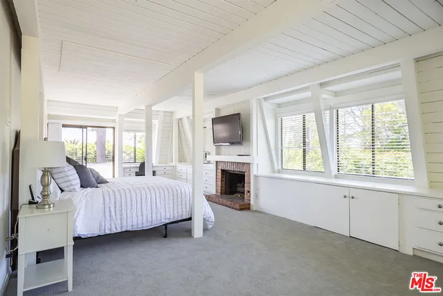 a bedroom with bed and flat tv