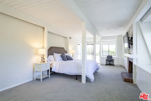 a bed room with a bed and a chair