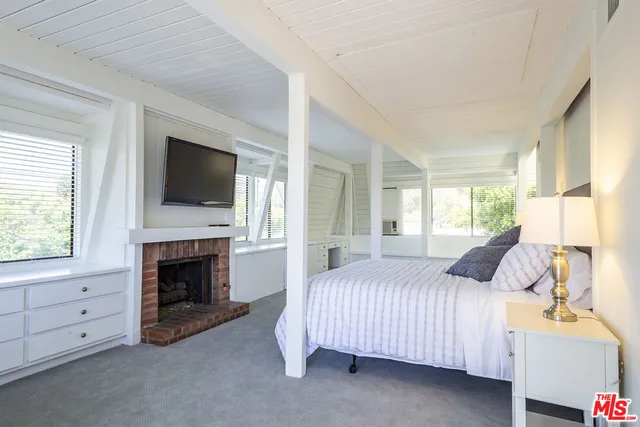 a bedroom with a bed and a fireplace