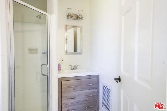 a bathroom with a sink vanity and a mirror