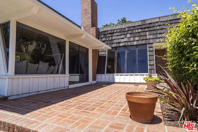 a view of a patio with table and chairs and potted plants