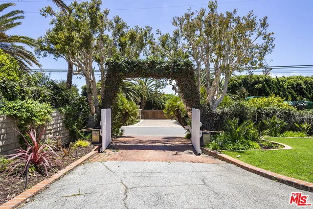 a view of house entrance and garden