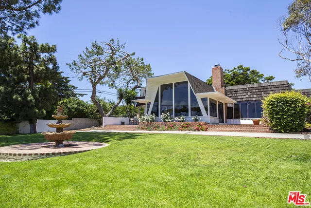 a view of a house with swimming pool and sitting area