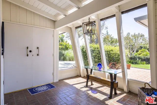 a living room with a floor to ceiling window and a table