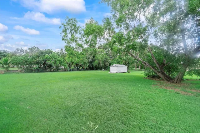 a view of a garden with houses in the background