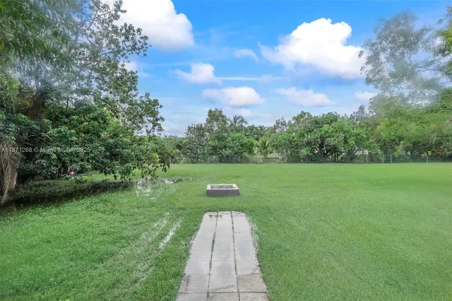 a view of a yard with large trees