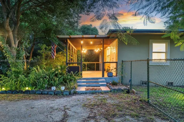 a view of backyard of house with green space