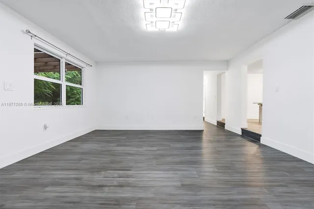 a kitchen with stainless steel appliances a refrigerator sink and cabinets