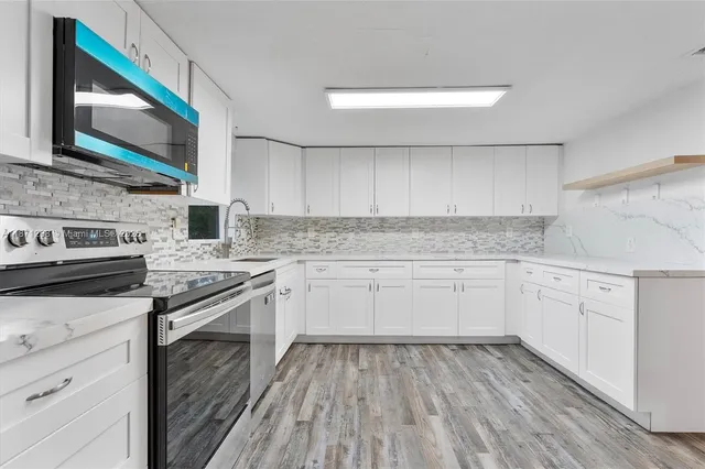 a view of a dining room with furniture and wooden floor