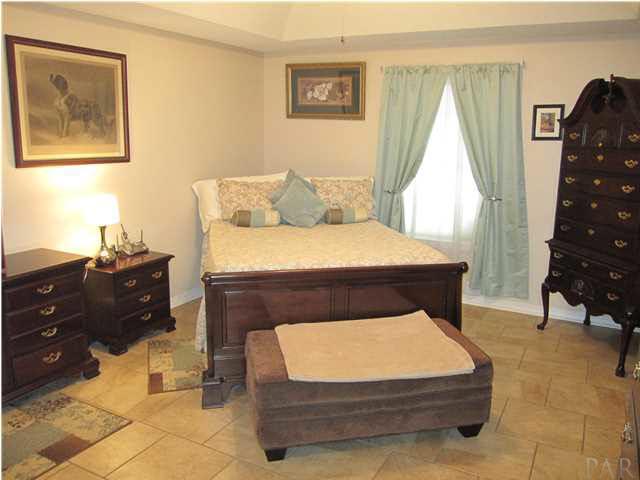 5918 Country Club Road Milton, FL 32570 - Photo 20 of 25 18" x 18" Italian Porcelain Tile adorns the master suite. Window view to private pool area in back yard.