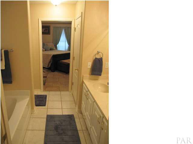 5918 Country Club Road Milton, FL 32570 - Photo 21 of 25 Master bathroom view from doorway to water closet. Double vanity to right. Linen closet just beyond vanity.