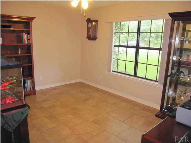 5918 Country Club Road Milton, FL 32570 - Photo 25 of 25 Additional bedroom at front of home.18' x 18" Italian Porcelain Tile carries into this room with a double window, vertical blinds & lighted ceiling fan.
