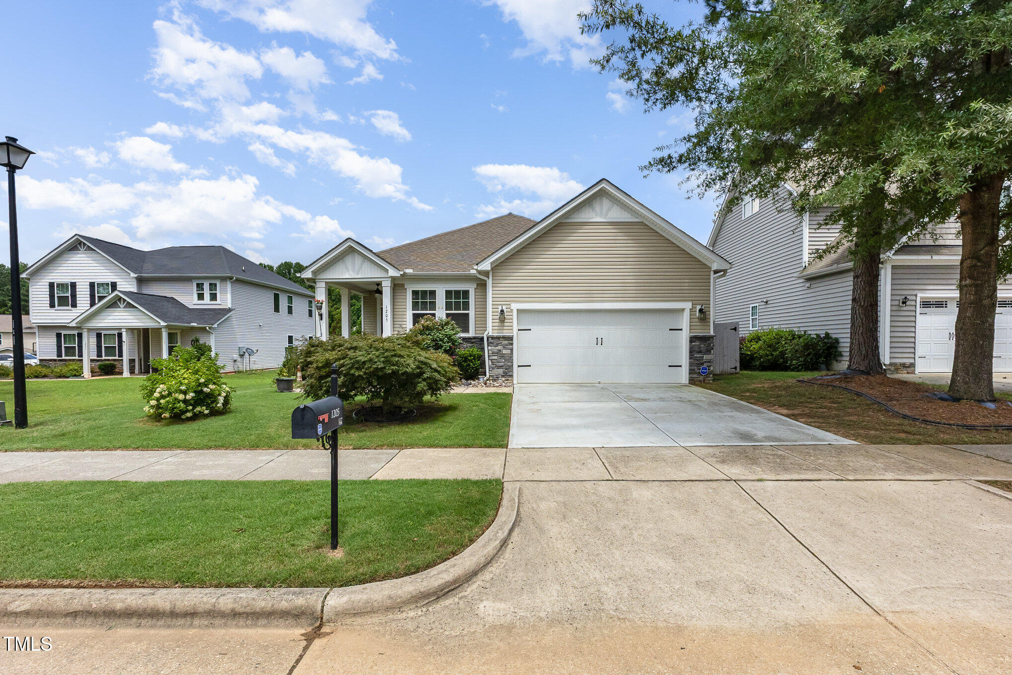 1205 Barnford Mill Road Wake Forest, NC 27587 - Photo 2 of 17 a front view of a house with a garden