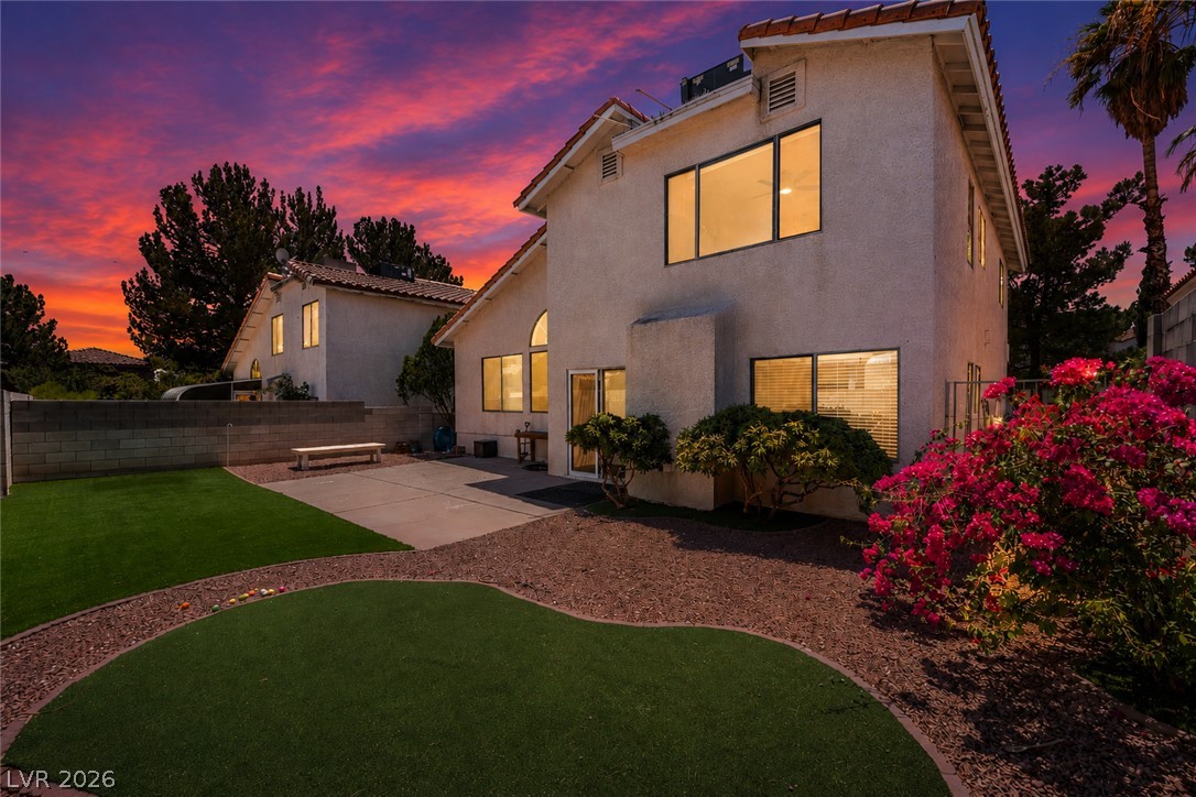 8872 Chapman Point Las Vegas, NV 89129 - Photo 27 of 29 A private backyard oasis with synthetic turf, mature landscaping, and an expansive concrete patio.