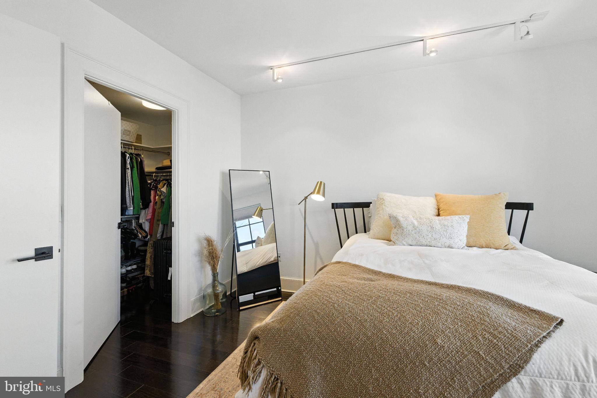 1011 M Street Northwest, Unit 901 Washington, DC 20001 - Photo 12 of 26 a bedroom with a bed and a walk in closet